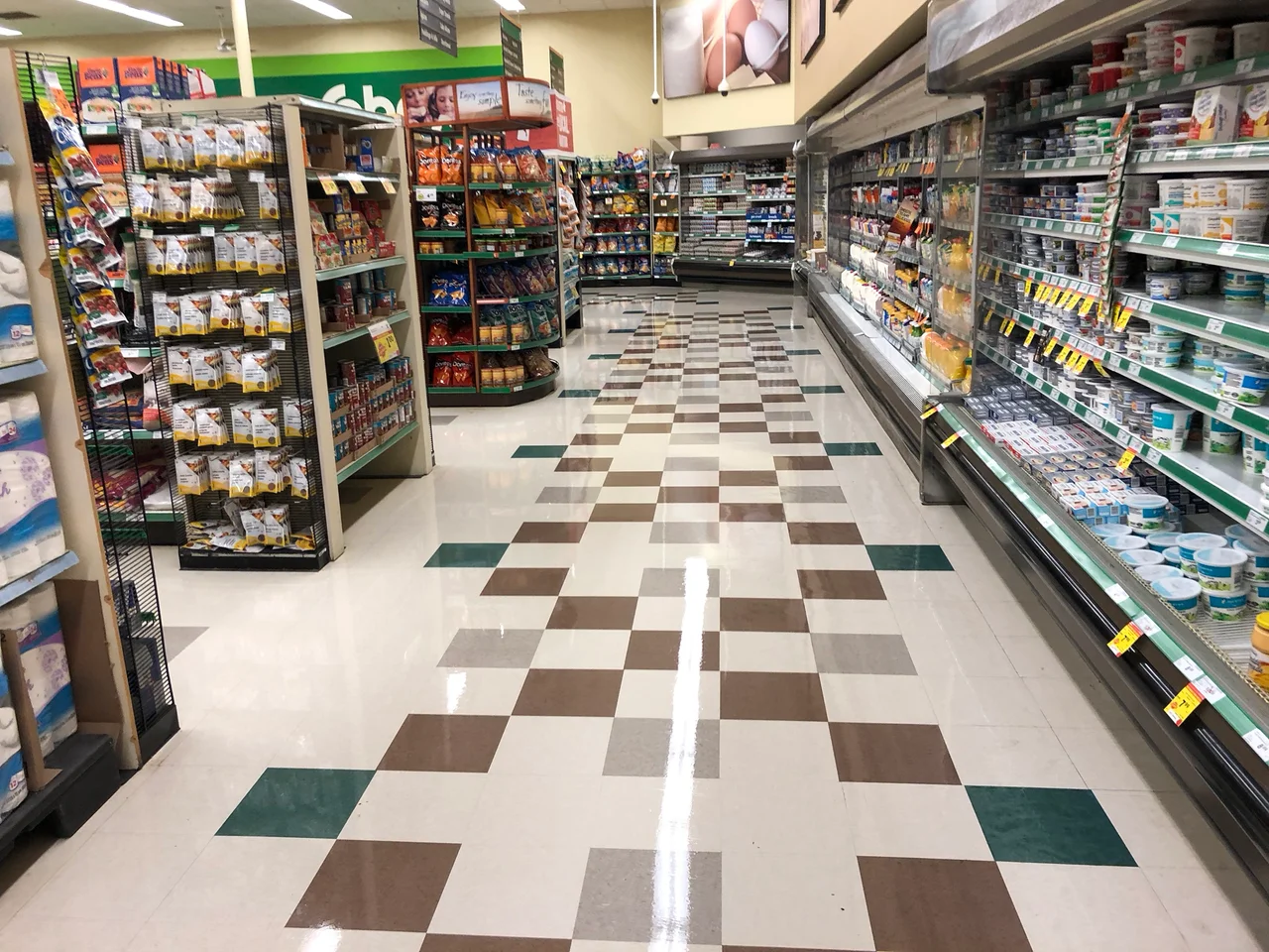 Freshly waxed tile floor in a grocery store aisle